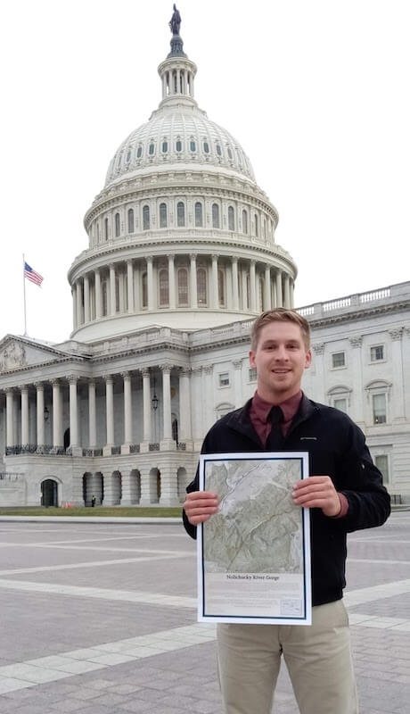 Man with a river map standing in front of the U.S. Capitol